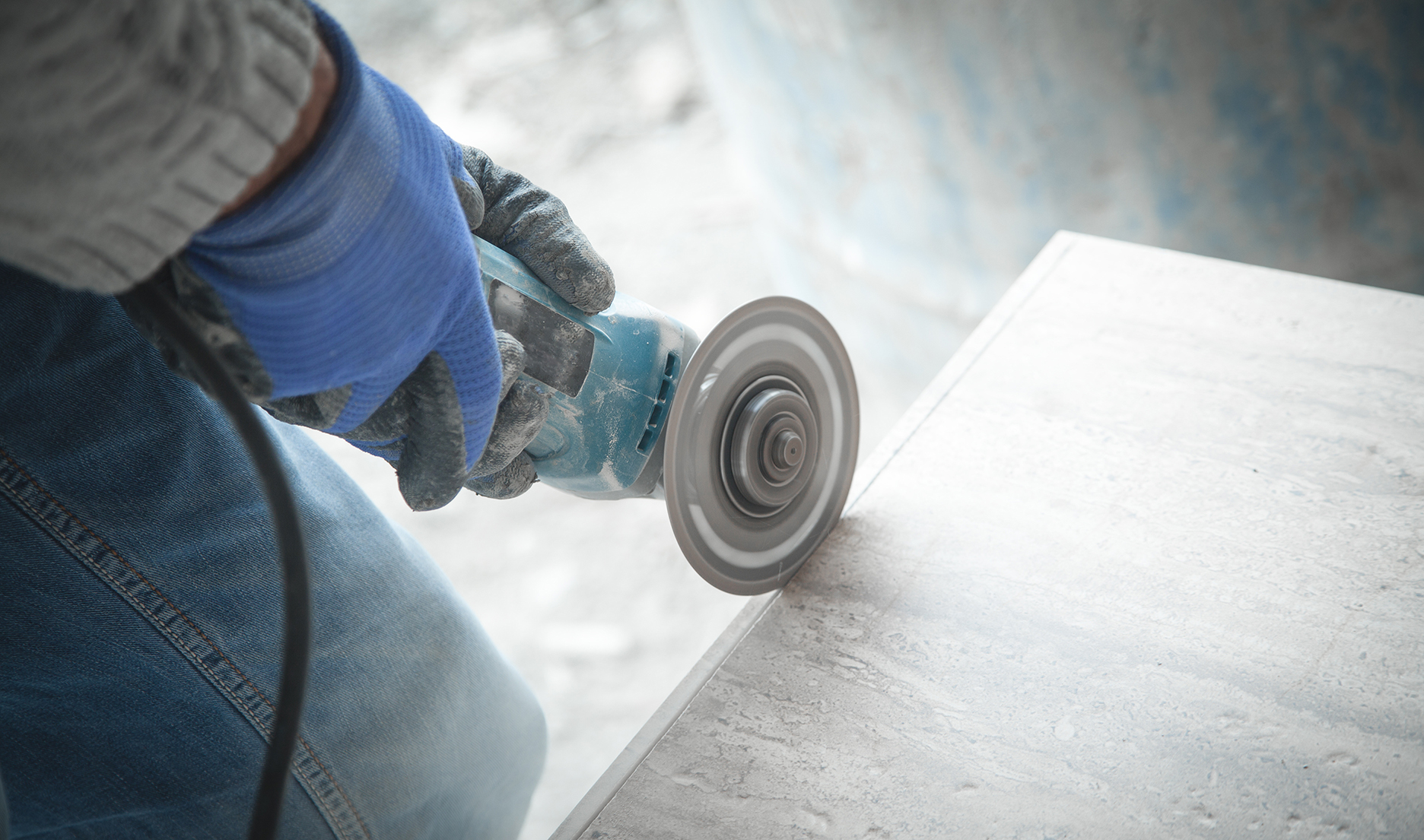 Worker cutting a stone with dust flying